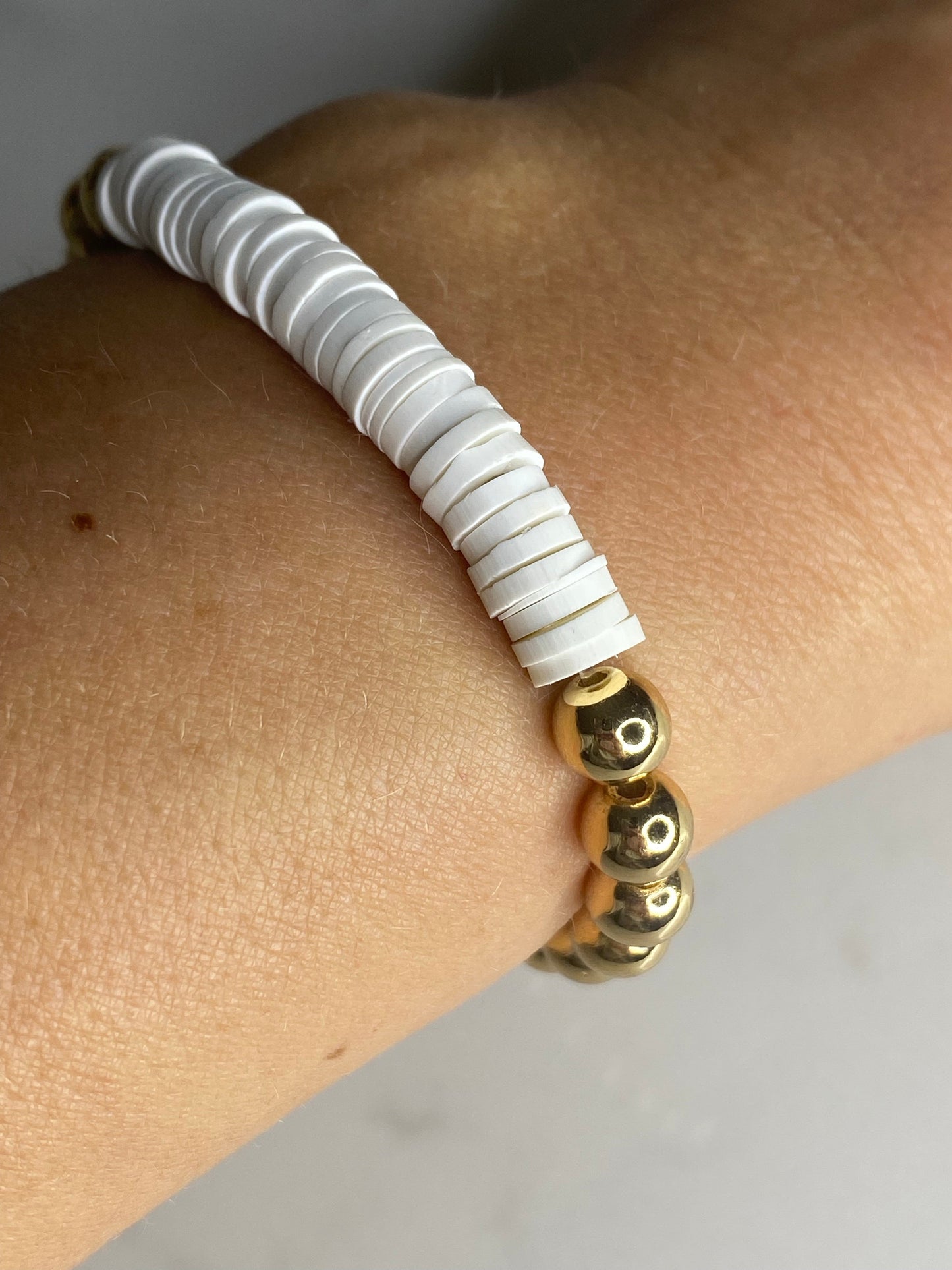 White heishi beads with gold plated hematite beads