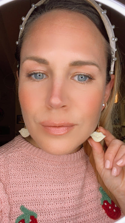 Sparkly resin lip 👄 earrings dangling from 14k gold plated hoops or danglers.