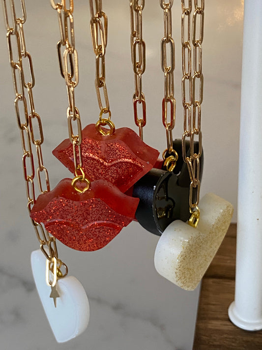 Lip resin necklace on gold plated chain.