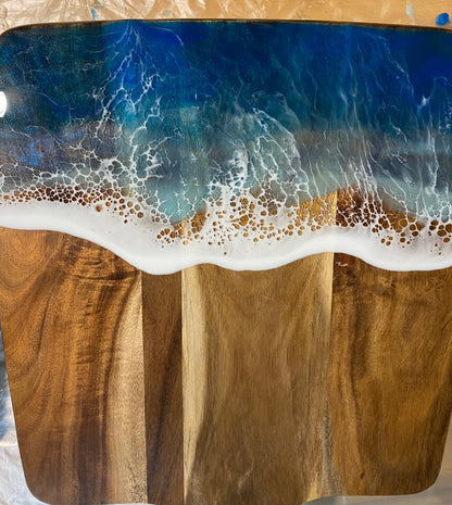 Acacia wood paddle board wth triple blue ocean waves.