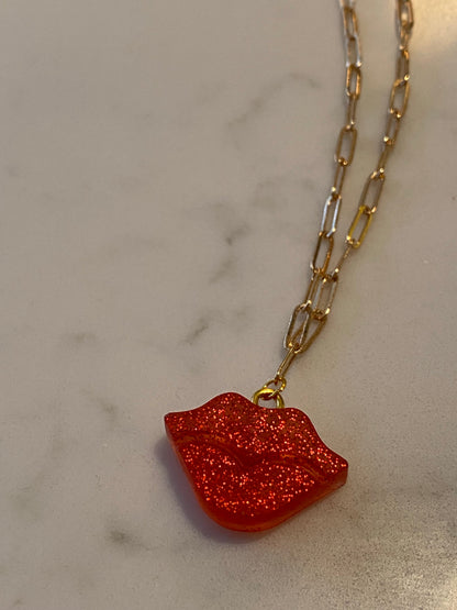 Lip resin necklace on gold plated chain.