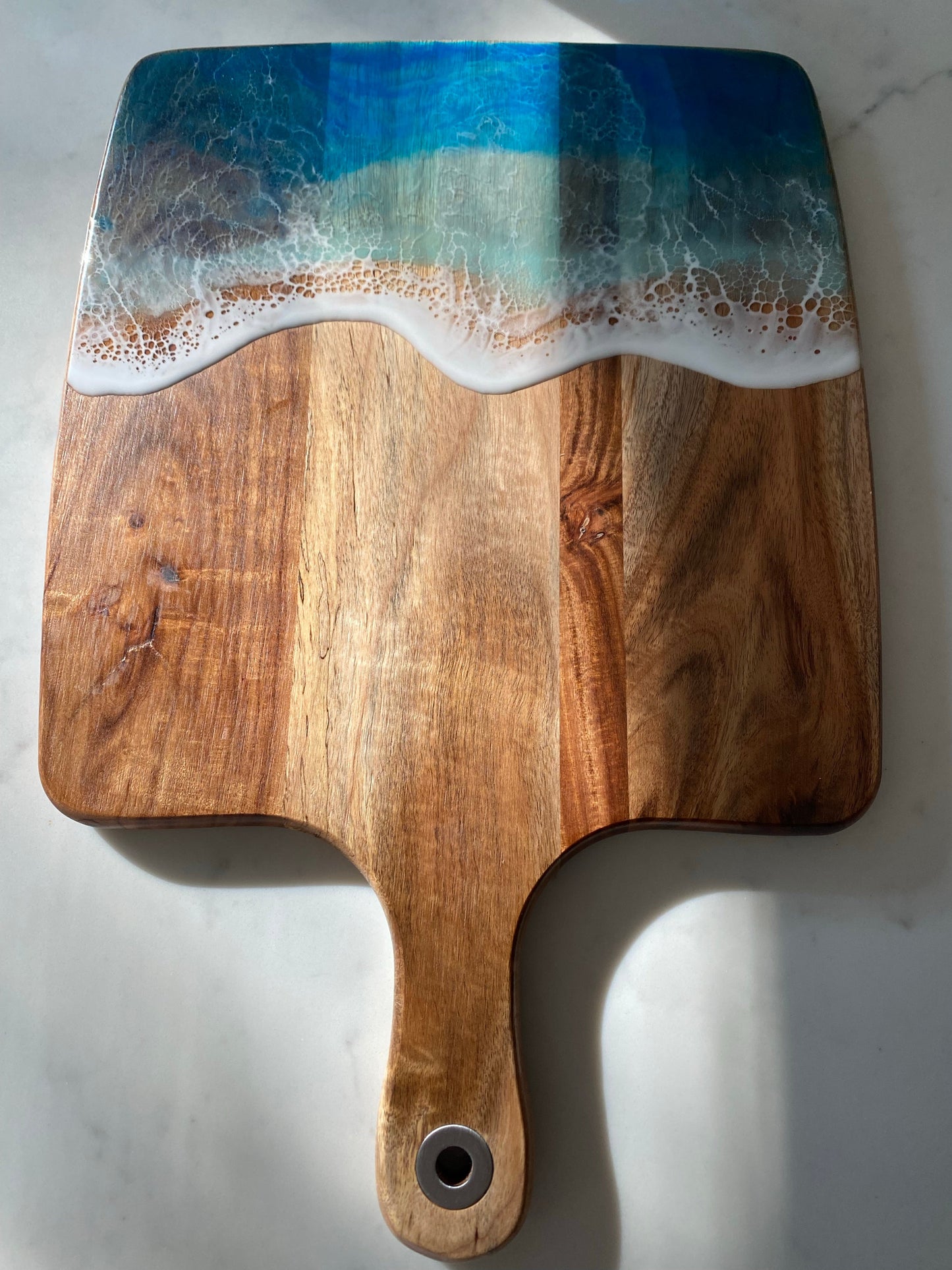 Acacia wood paddle board wth triple blue ocean waves